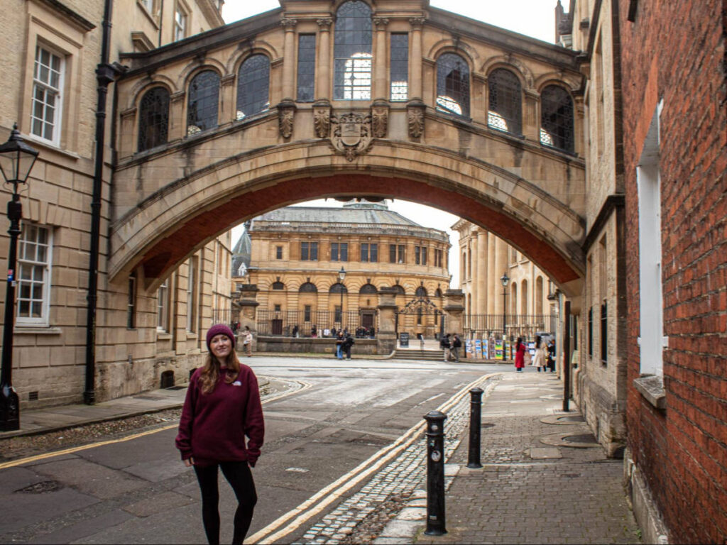 The author Rebecca Rayner, posing for a photo in front of the Bridge of Sighs