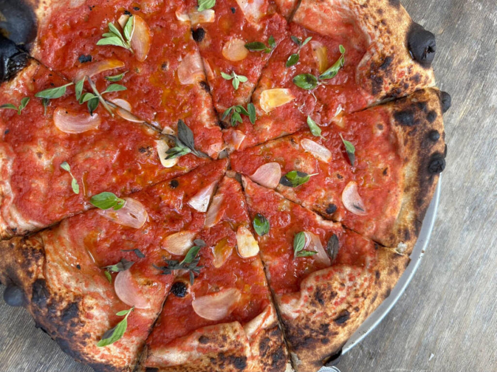 Closeup look of the pizza with red sauce and yuzu oil 
