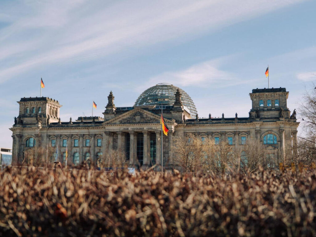 Panoramic view of the building of Reichstag and the flags of Germany around