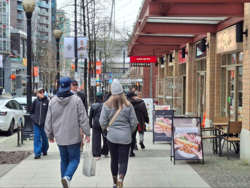 People walking along the restaurants in Robson Street
