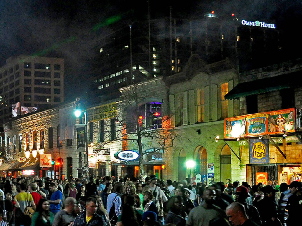 View of Revelers filling up Sixth Street