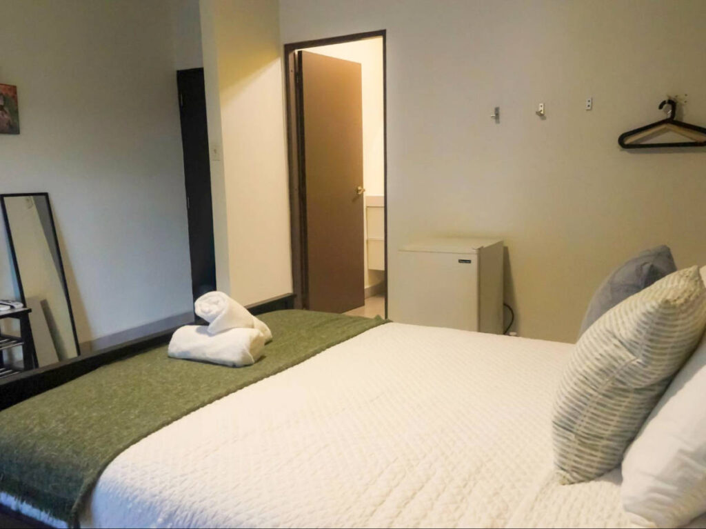 View of the room entrance and bathroom in Rincón Plaza Hotel