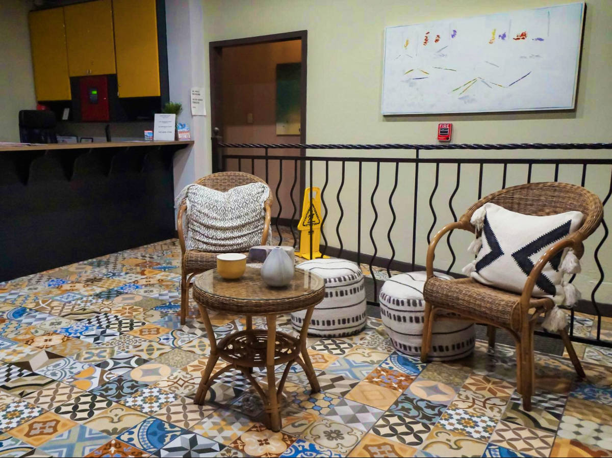 View of the mosaic tiles and cozy seating area in the lobby of Rincón Plaza Hotel