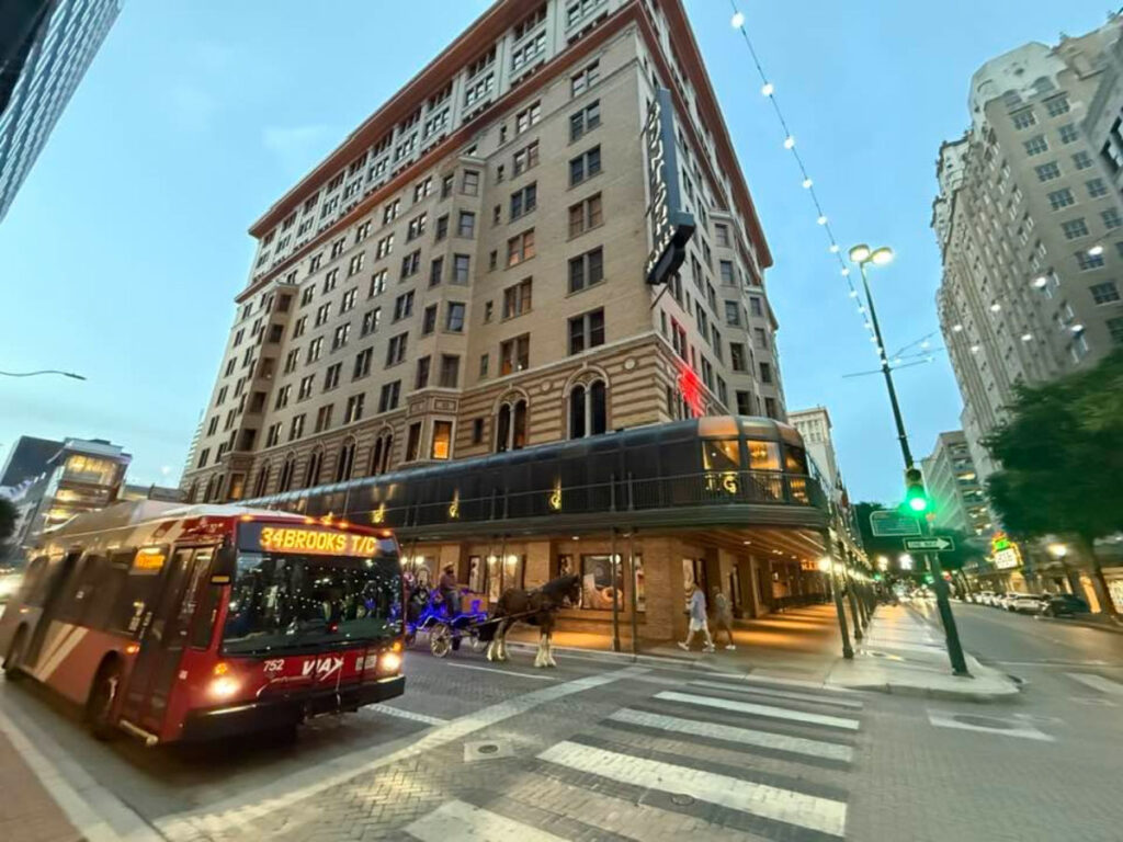 View of a building, a bus, and a horse carriage during the River City Ghost Tour 