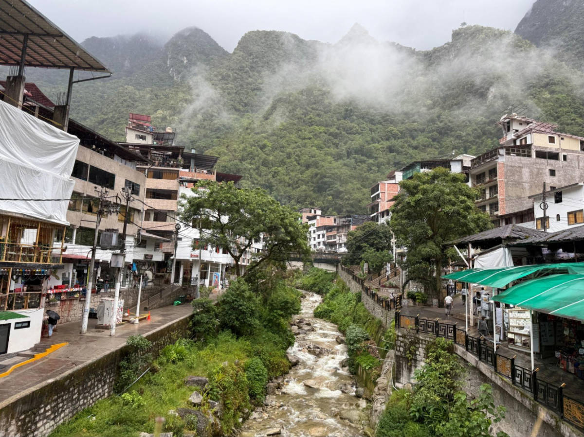 View of the clustered buildings around the river in Aguas Calientes
