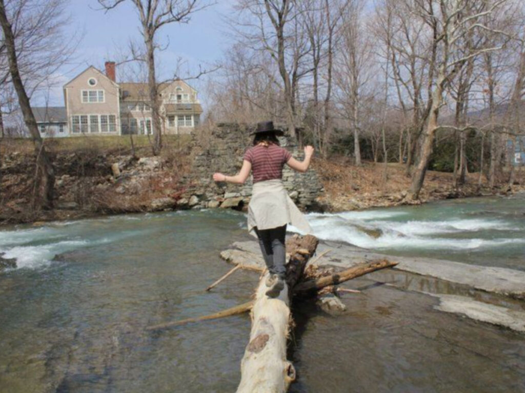 Author Meg crosses the river on the log in Williamstown