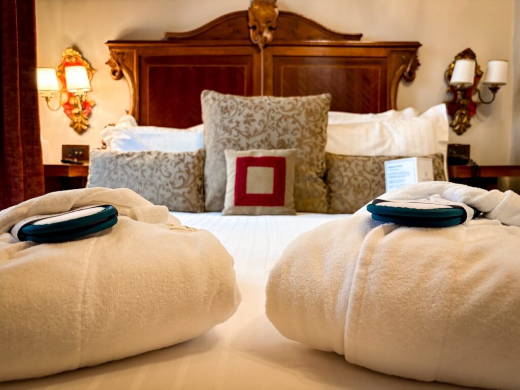 Robes and slippers on the bed at Palazzo Priuli