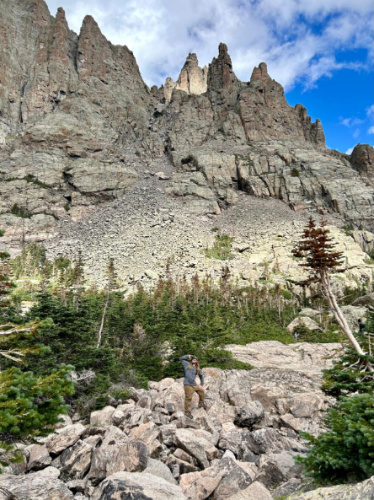 The author's husband posing for a photo at the Rocky Mountain National Park