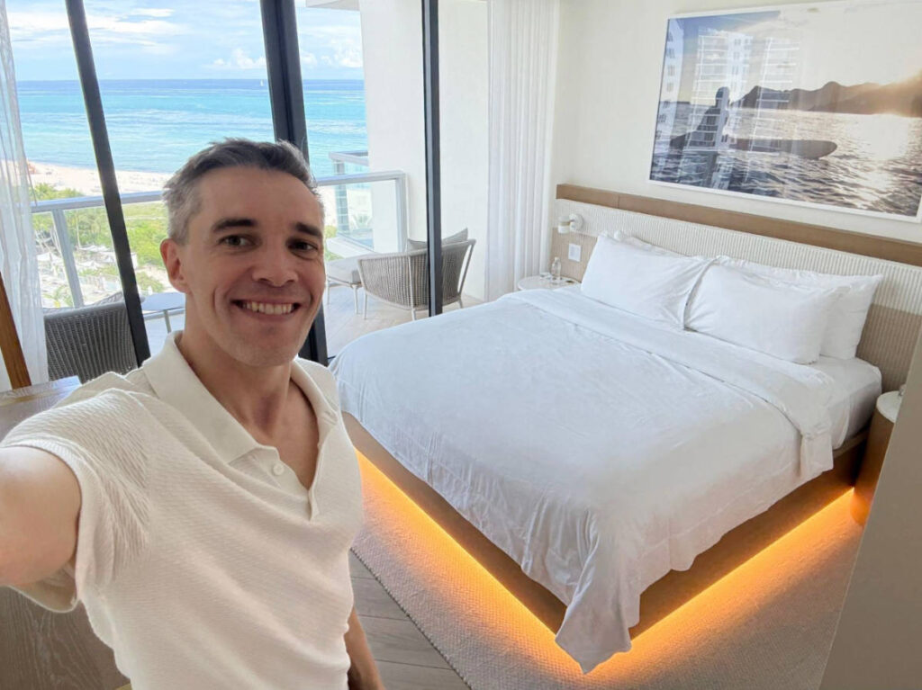 Travel Lemming founder, Nate Hake smiling for a selfie on his room at the W South Beach hotel