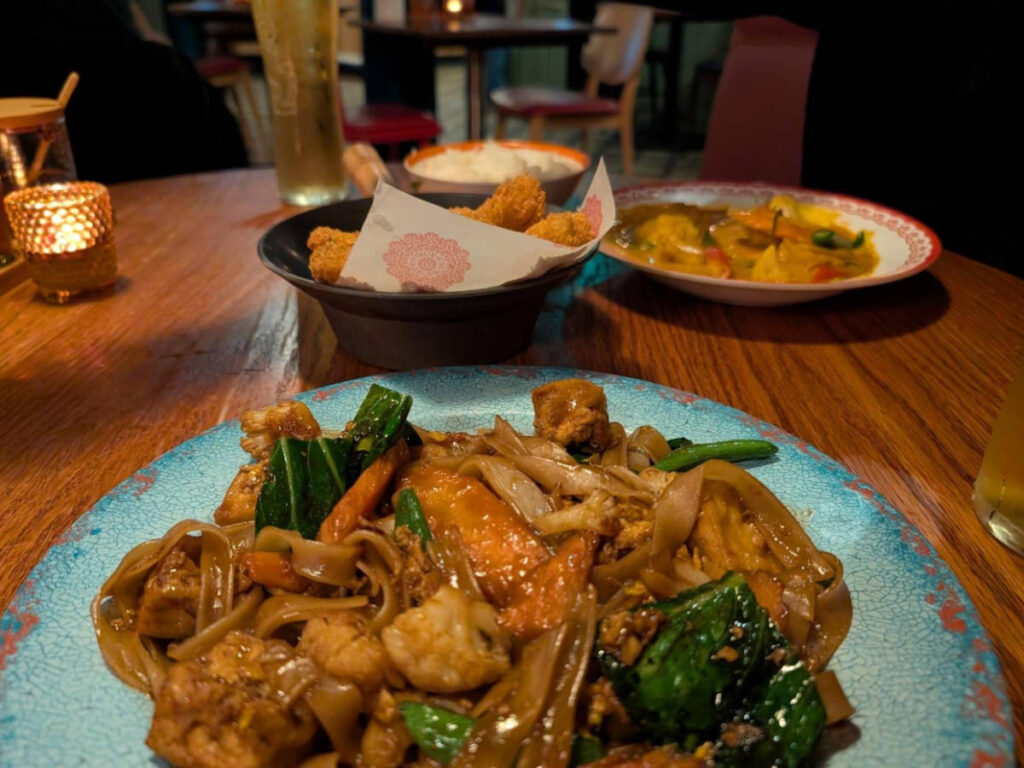 Closeup look of the plates of Thai Pad See Ewe and Gaeng Panang in Rosa’s Thai Glasgow