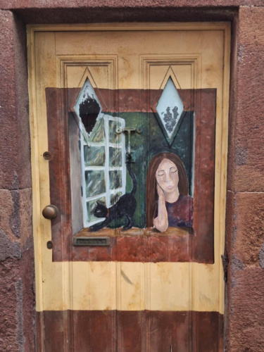 Close-up look of the painted door in Rua Santa Maria