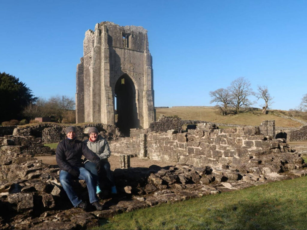 A couple sitting near the ruins of Shap Abbey