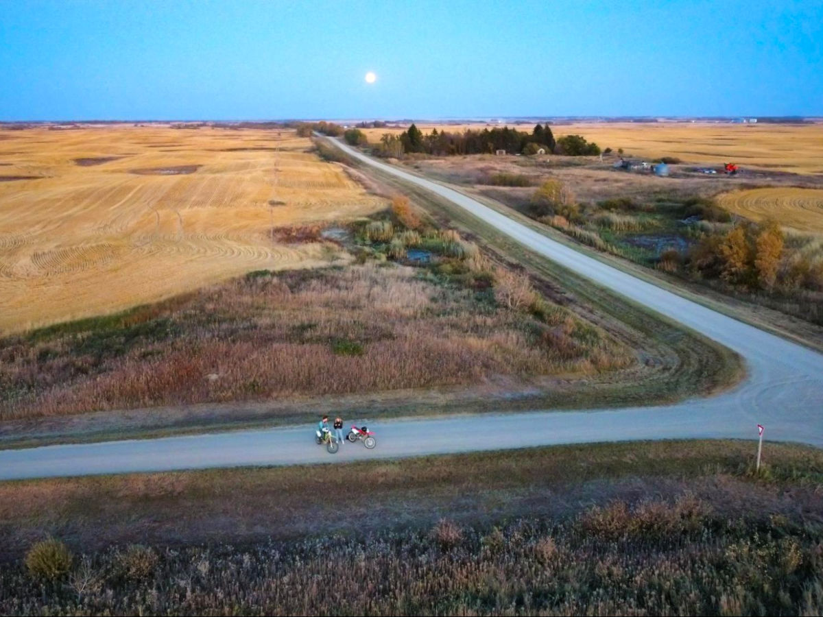 Drone shot view of Taylor and her brother dirtbiking in rural Saskatchewan