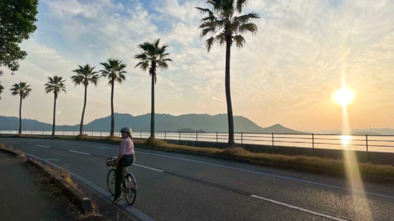 The author Ruthie Walters cycling to Sunset Beach on Ikuchijima island at sunset