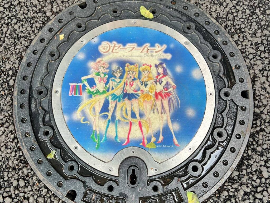 A Sailor Moon manhole seen across Minato-ku