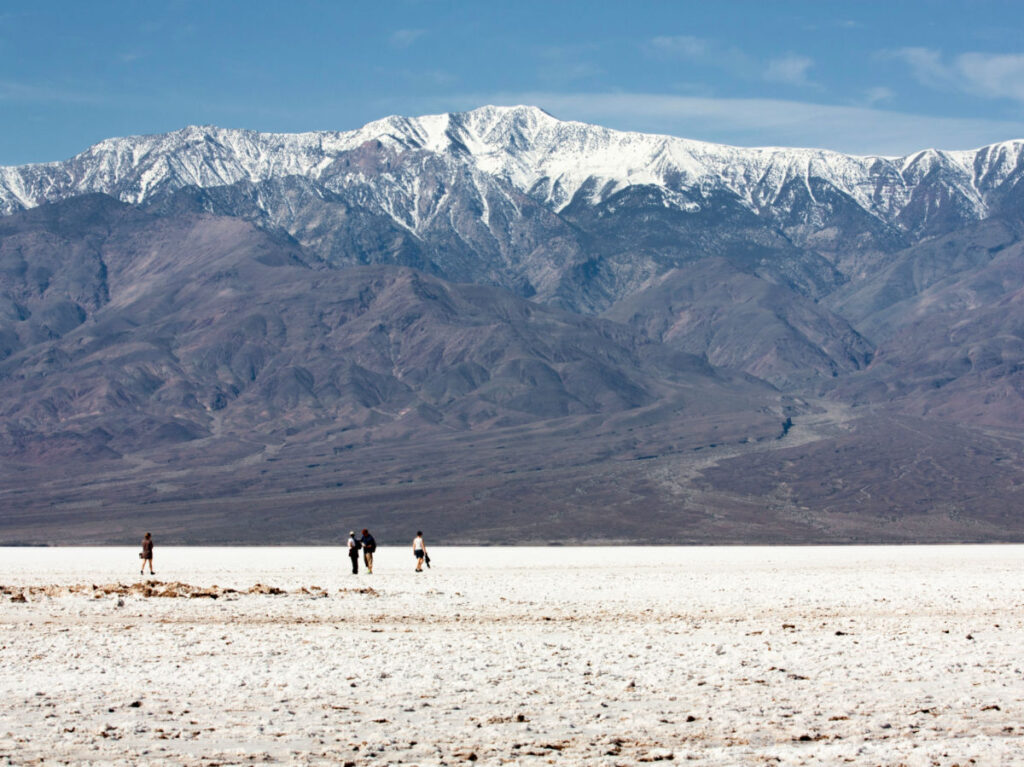 People exploring the vast salt flats at Badwater Basin