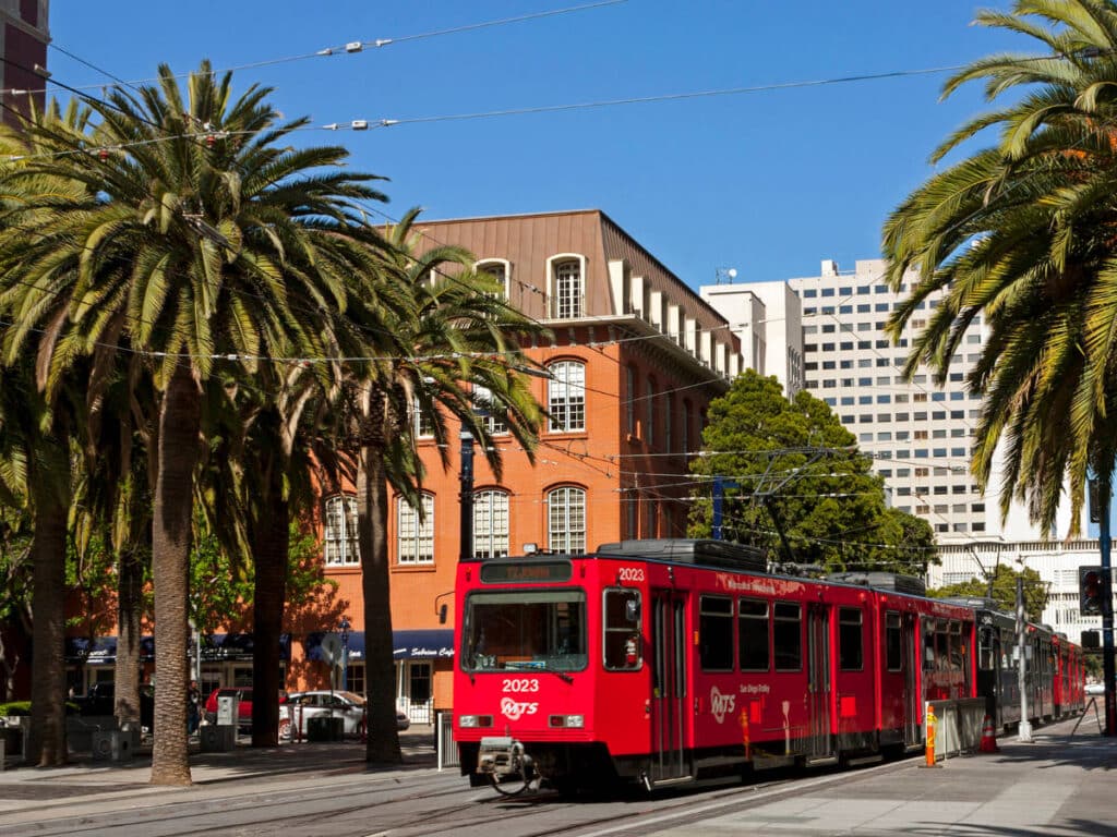 The red trolley wandering on a street in San Diego