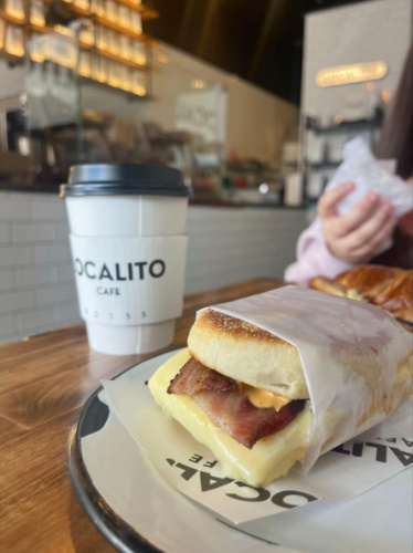Closeup look of the breakfast sandwich and latte at Localito Cafe