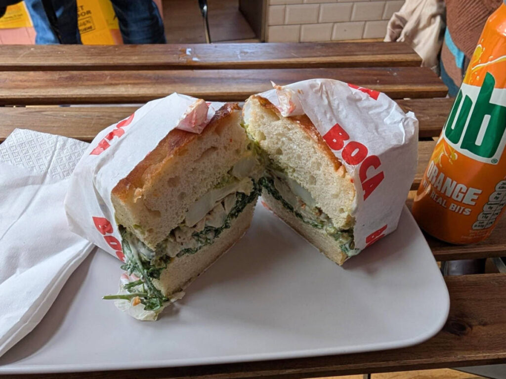 Closeup look of the roasted cauliflower, Caesar salad and Parmesan focaccia sandwich split in half