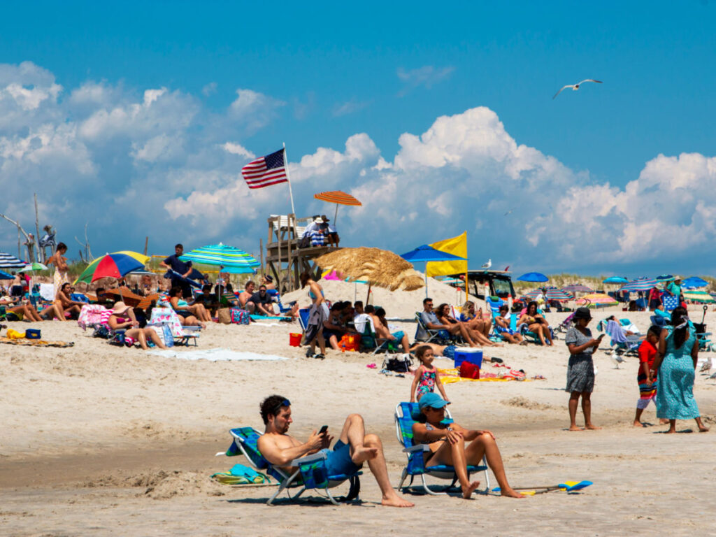 People enjoying a sunny day on Fire Island's sandy beach