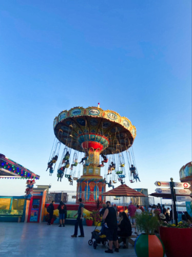 View of the crowd enjoying the swings ride at the Santa Cruz Beach Boardwalk