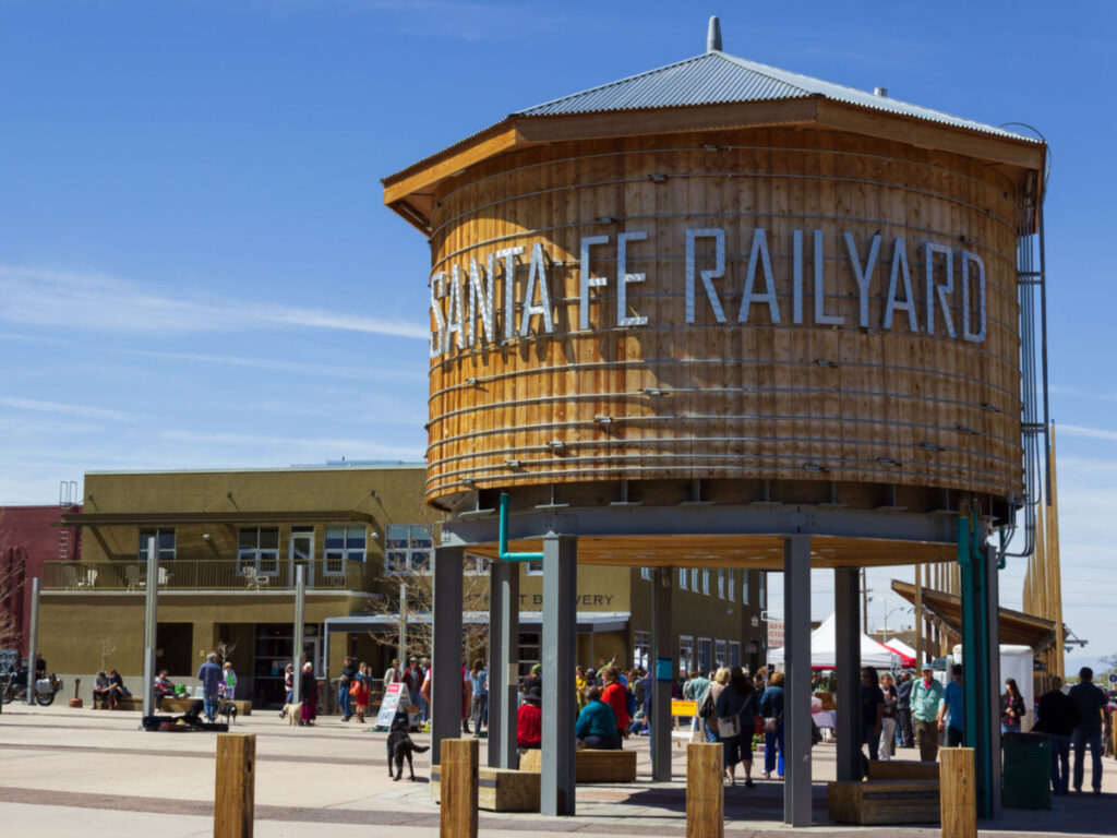 The Santa Fe Rail Yard water tower with people walking in background