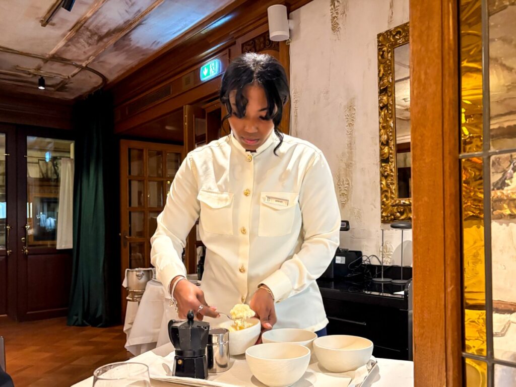 A Santo Mare waitress making tiramisu