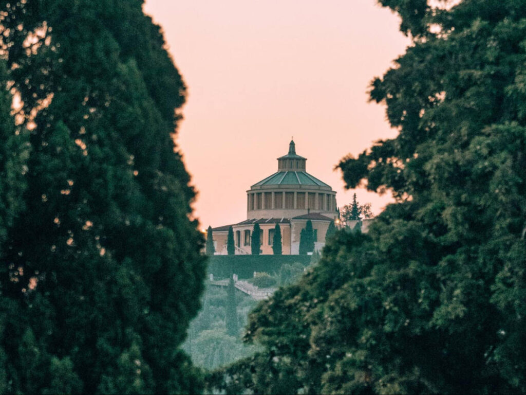 View of the Santuario della Madonna di Lourdes behind the greenery