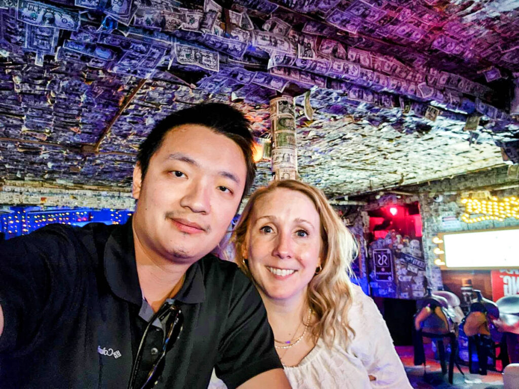 The author Sarah Heath and her husband smiling inside The Basement Bar