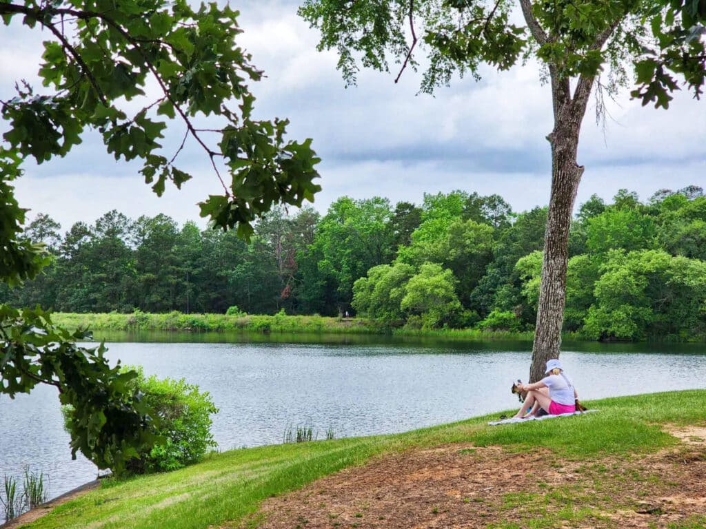 The author Sarah Heath and her dog, enjoying the relaxing view of the lake in Tyler State Park
