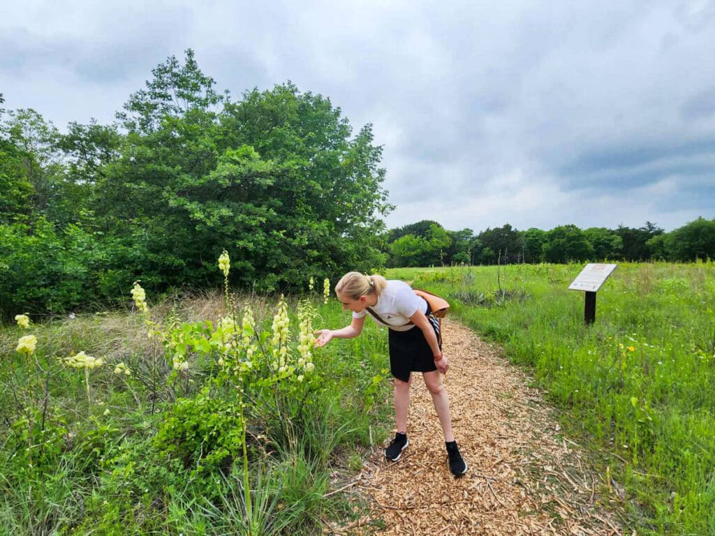 The author Sarah Heath, enjoying the blooming yuccas on the Prairie Trail