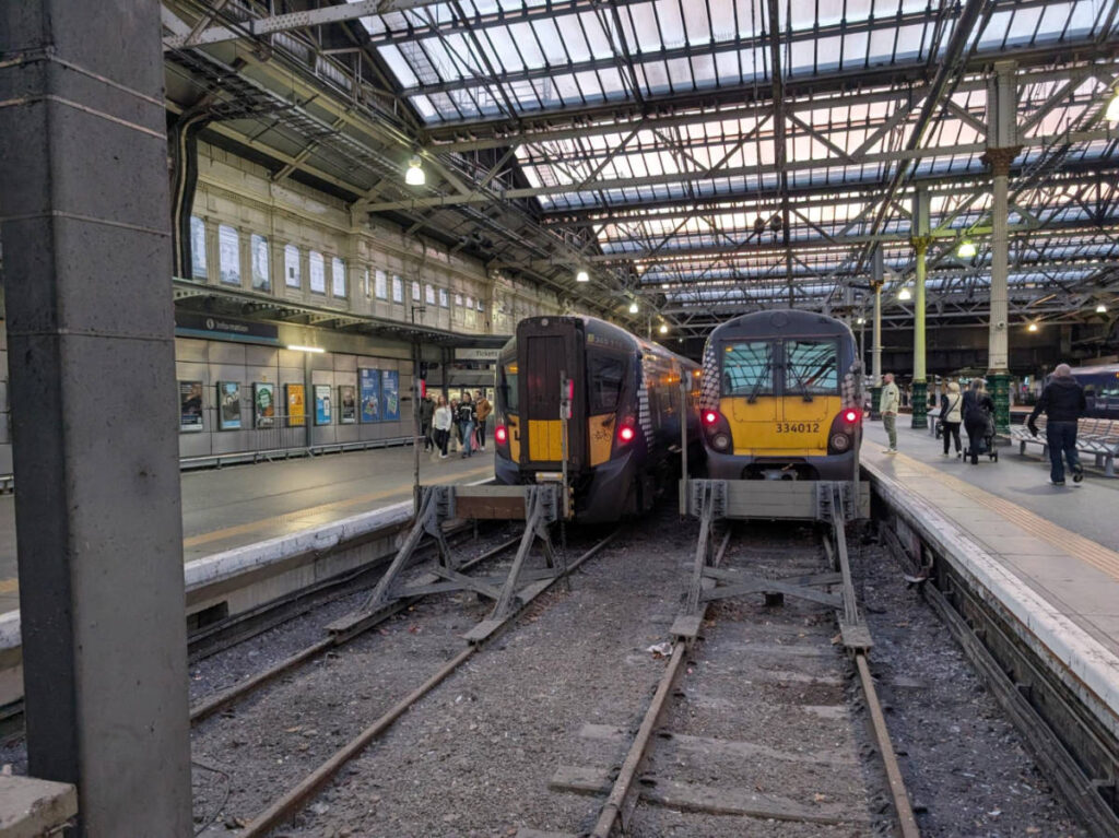 Two yellow trains on the tracks