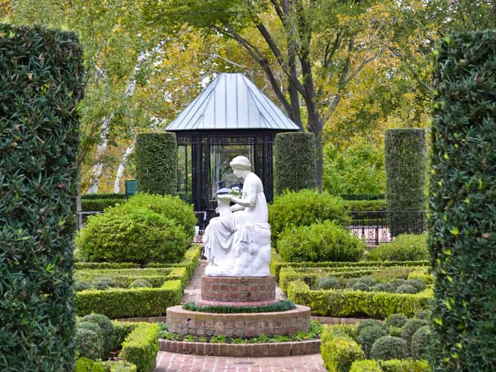 A sculpture of a woman in the middle of the garden at the Bayou Bend