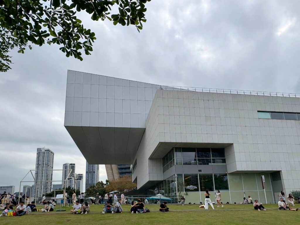 People relaxing on the lawns outside the Sea World Culture and Arts Centre