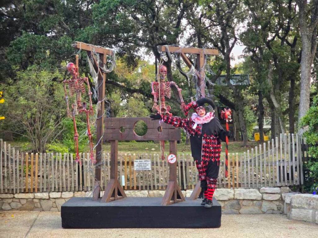 A scary clown and skeleton hanging during SeaWorld San Antonio’s Halloween celebration