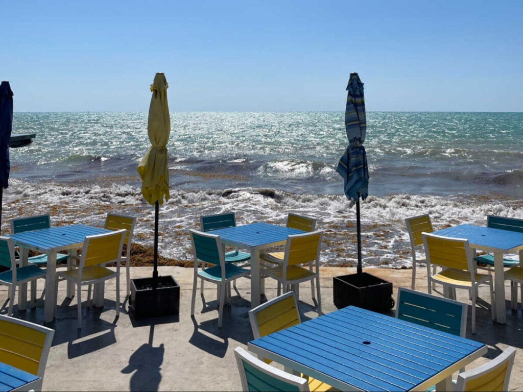 View of the vibrant cafe seating at the beachfront of Mansion on the Sea