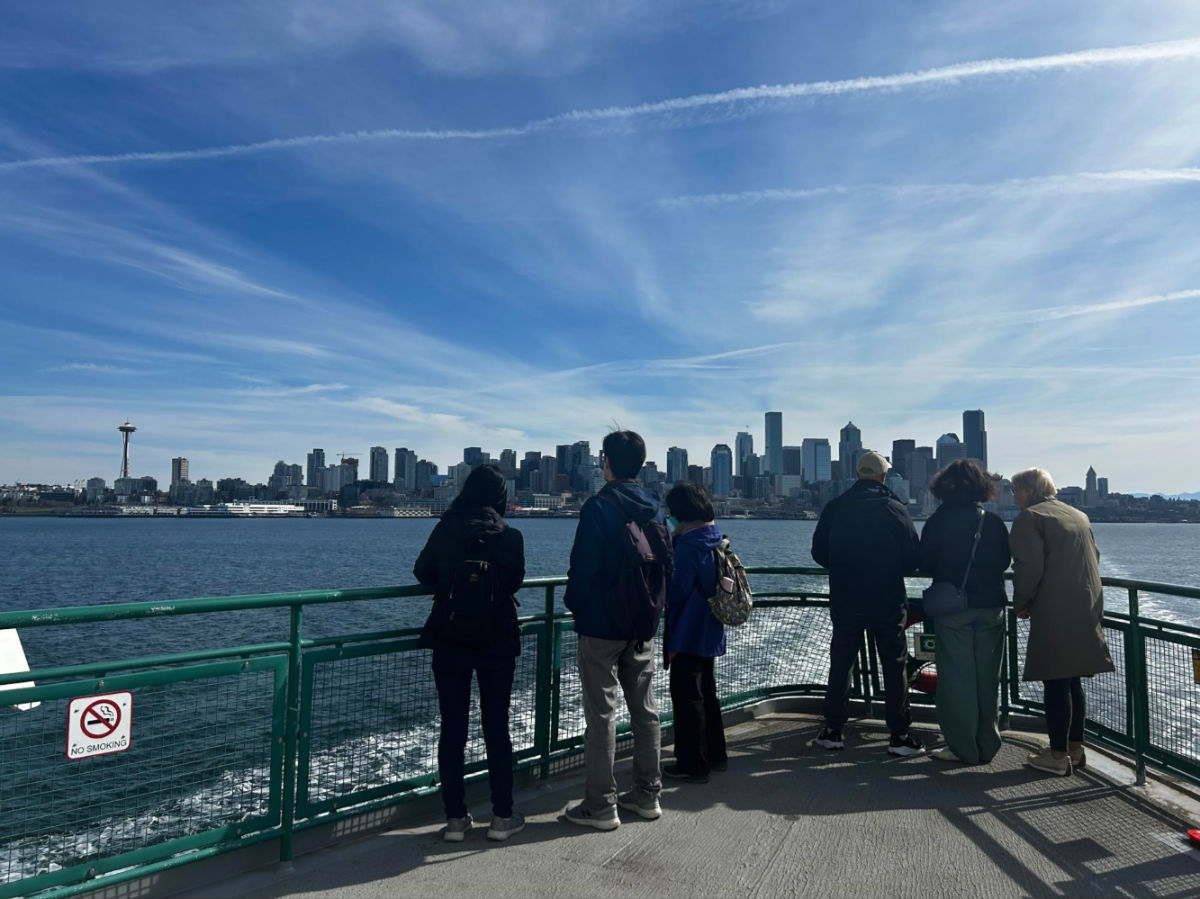People admiring the Seattle skyline from the ferry