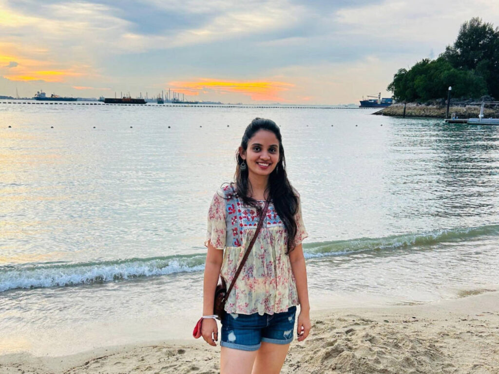 The author, Advaita smiling for a photo during sunset in Sentosa Island