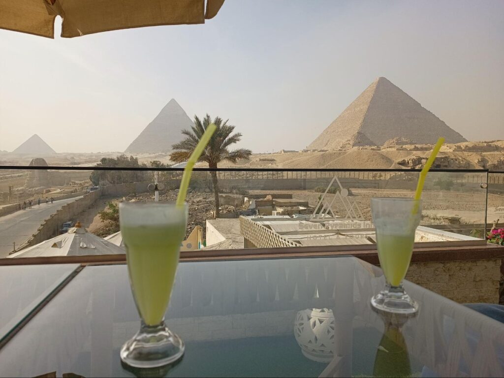 Rooftop terrace of Seven Pyramids View Inn, with a  view of the Great Pyramids of Giza