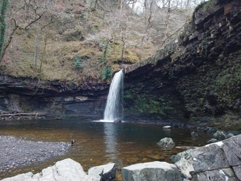 View of the cascading Sgwd Gwladys waterfalls in the forest
