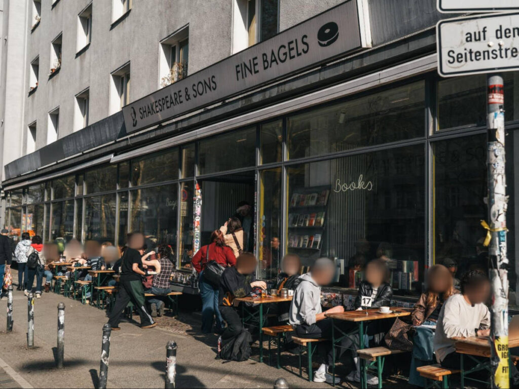 People chilling at the Shakespeare & Sons terrace on a sunny day