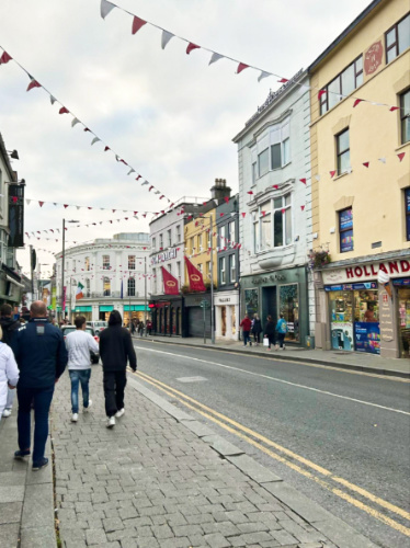 People walking along street of shops