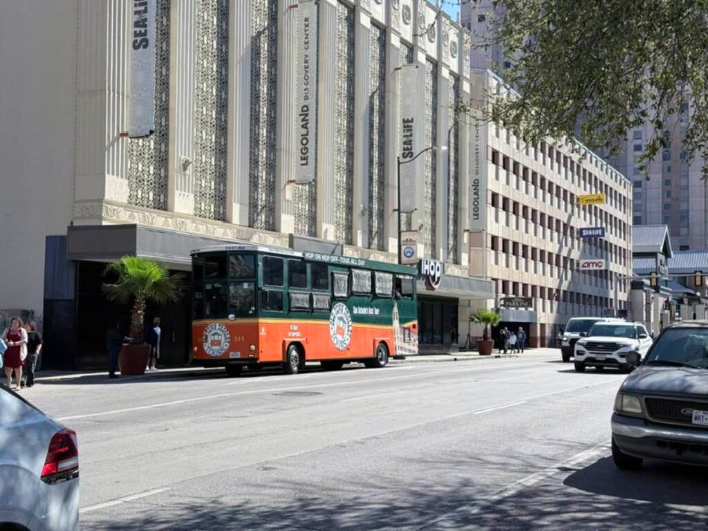 A bus parked in front of the Shops at Rivercenter