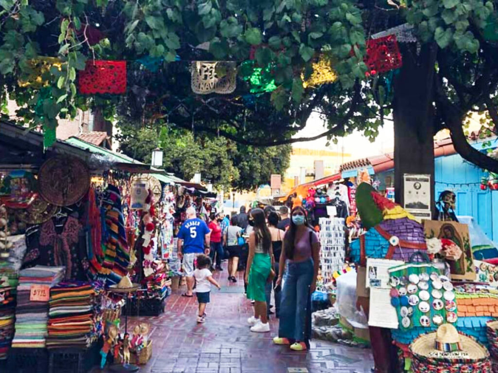 People looking at the colorful shops in the Olvera Street
