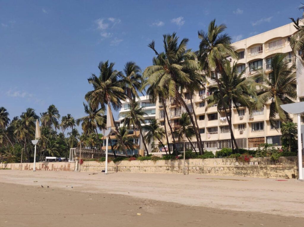Panoramic view of the hotel along the palm-lined shore of Juhu Beach