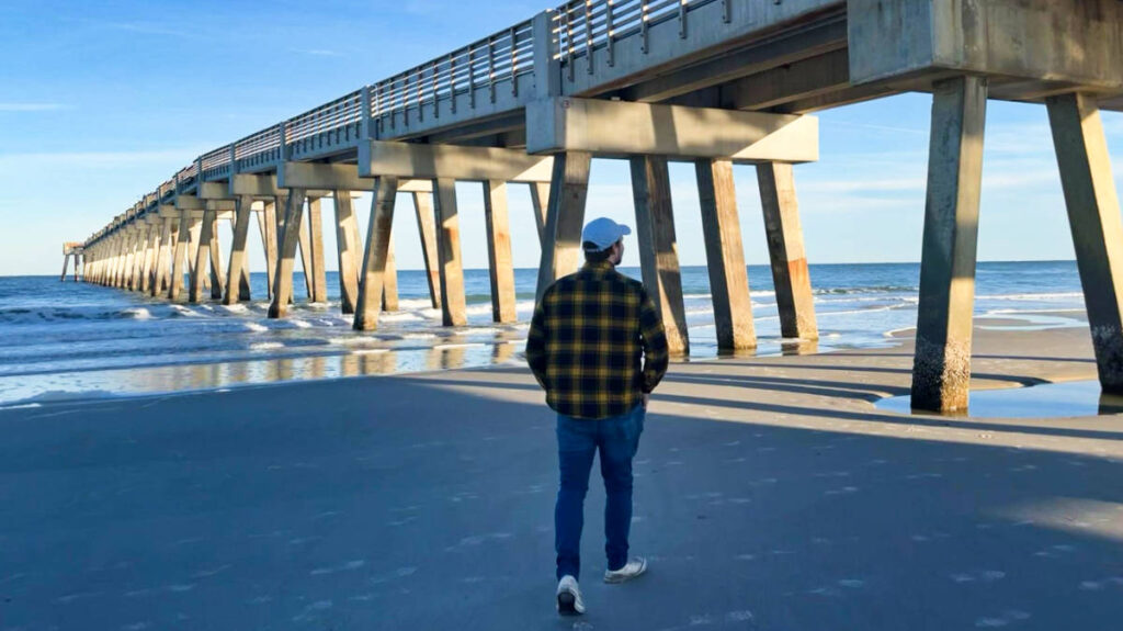 The author Ethan Thoren, walking along the shoreline at Jacksonville Beach