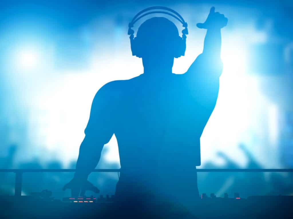 A silhouette of the DJ at a nightclub