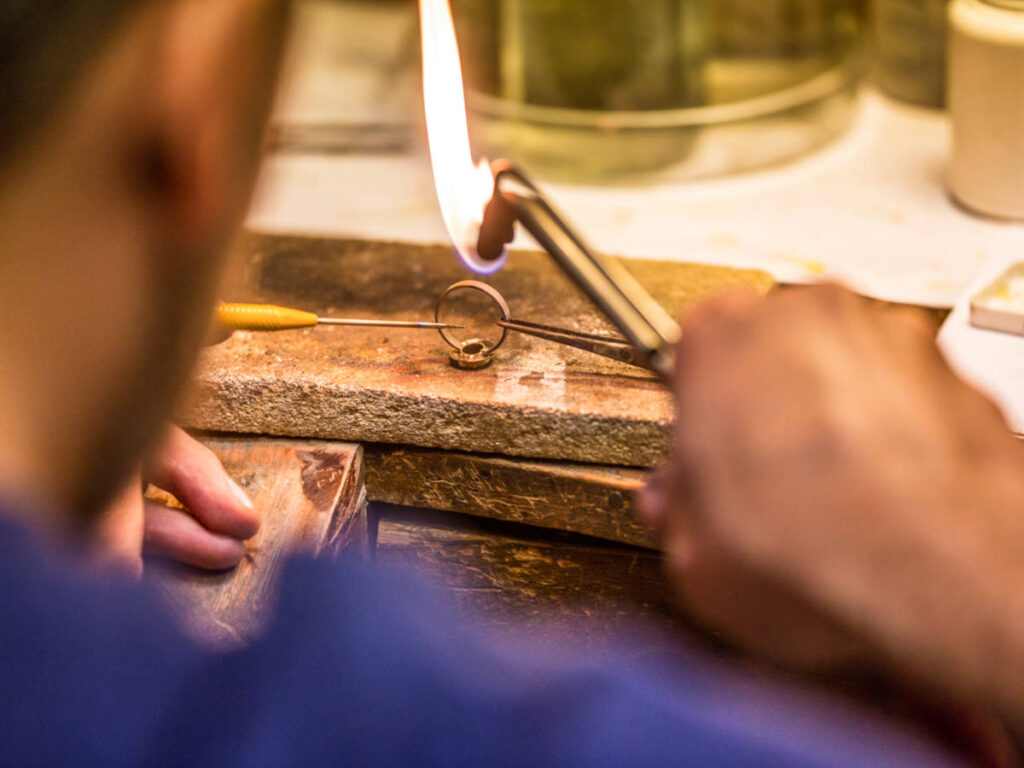 A goldsmith crafting a wedding ring