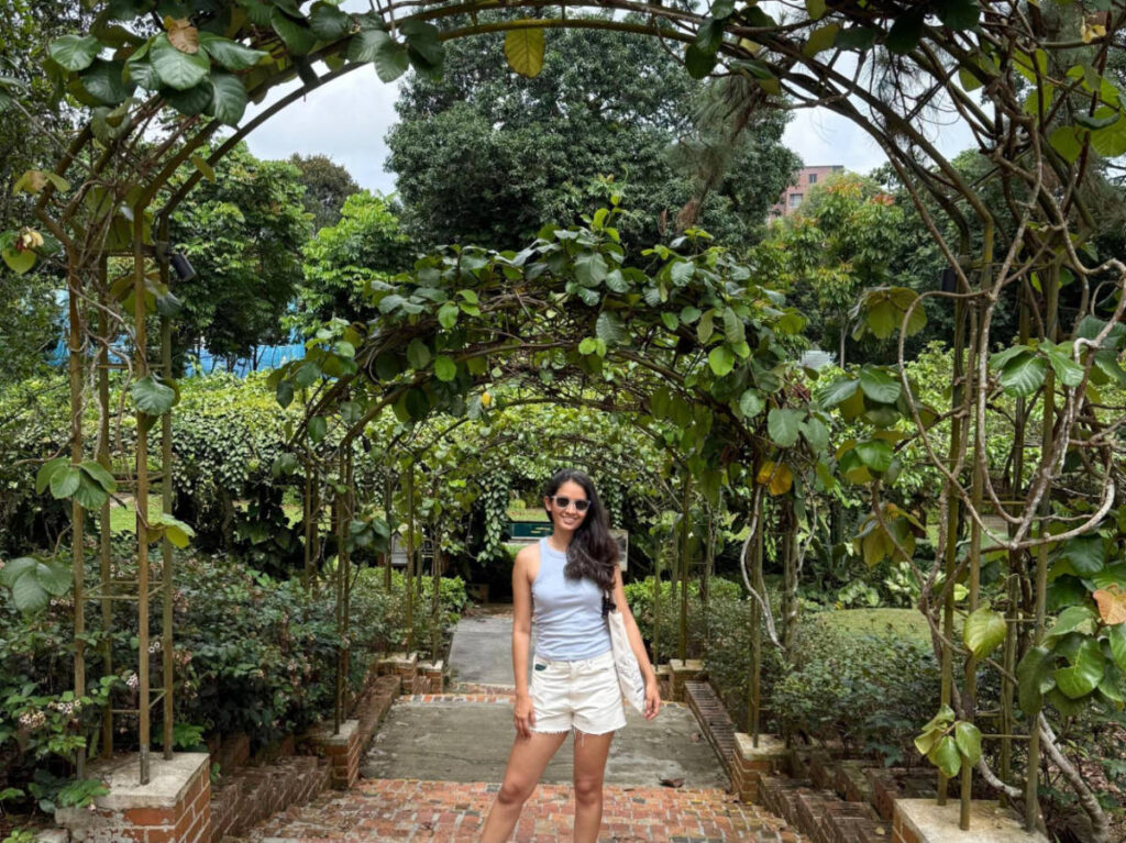 The author, Advaita smiling for a photo in Singapore Botanic Gardens