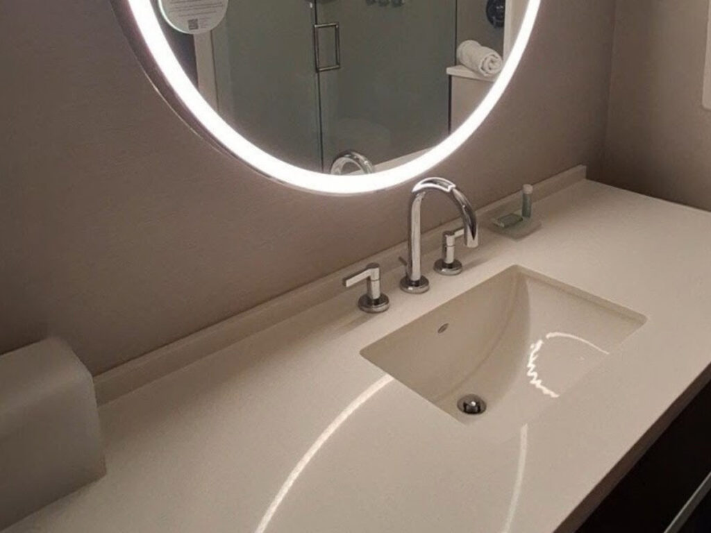 The sink and counter space of the hotel room